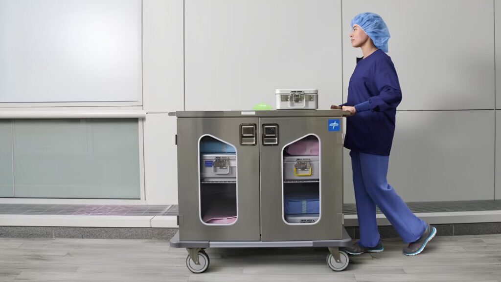 Hospital staff transporting medical devices and surgical instrumentation through a healthcare facility to support operating room procedures and last-mile medical logistics.